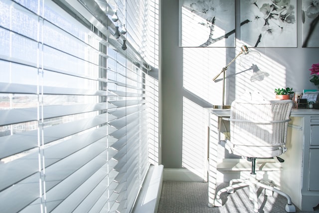 Sun light coming through white blinds in a room