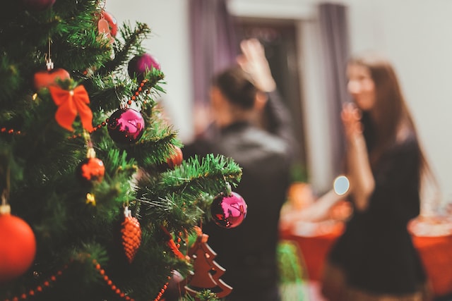 Selective focus on Christmas Tree and two girls in the blurred background